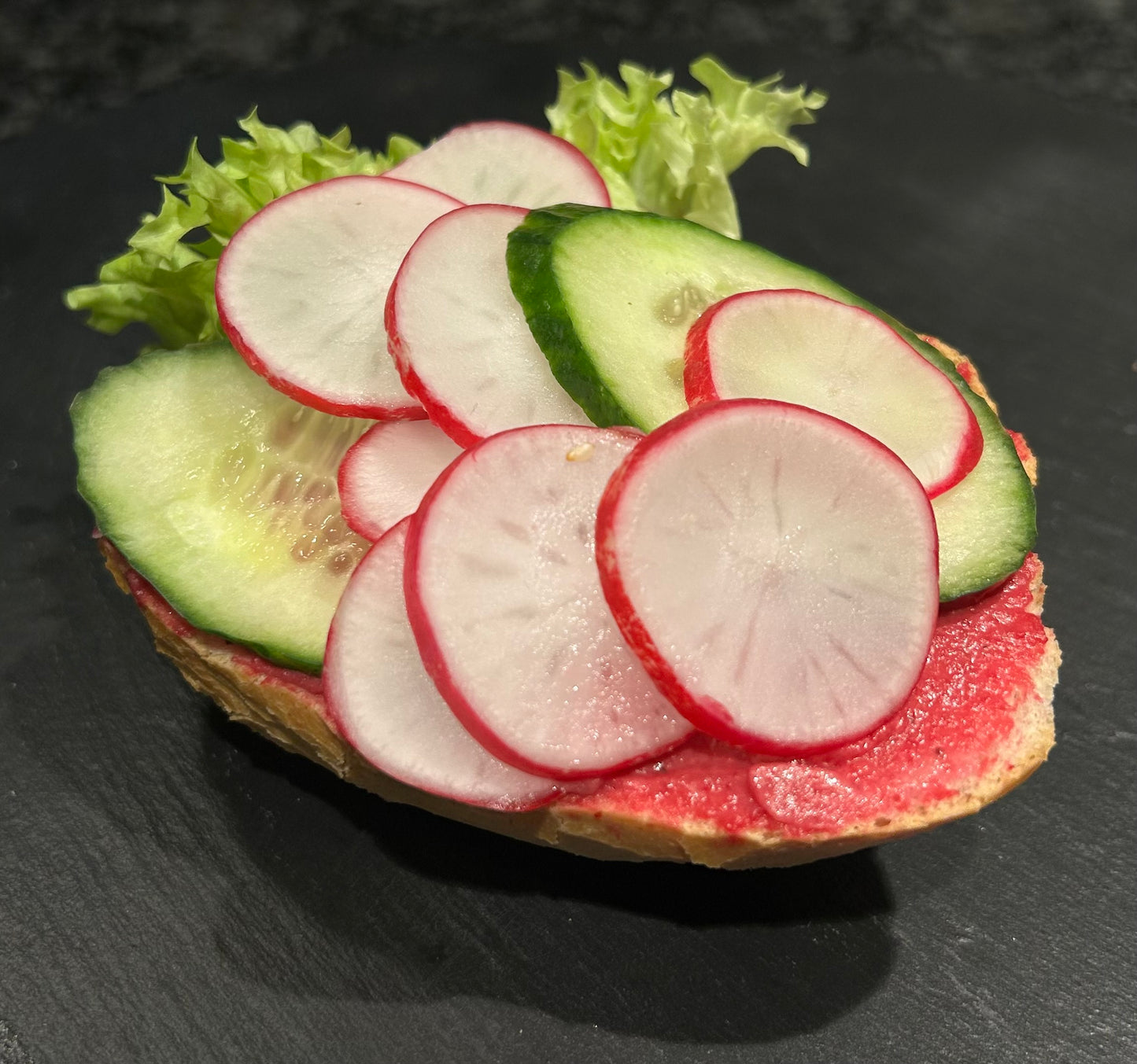 Halbes Weizenbrötchen mit Rote-Bete-Aufstrich - vegan